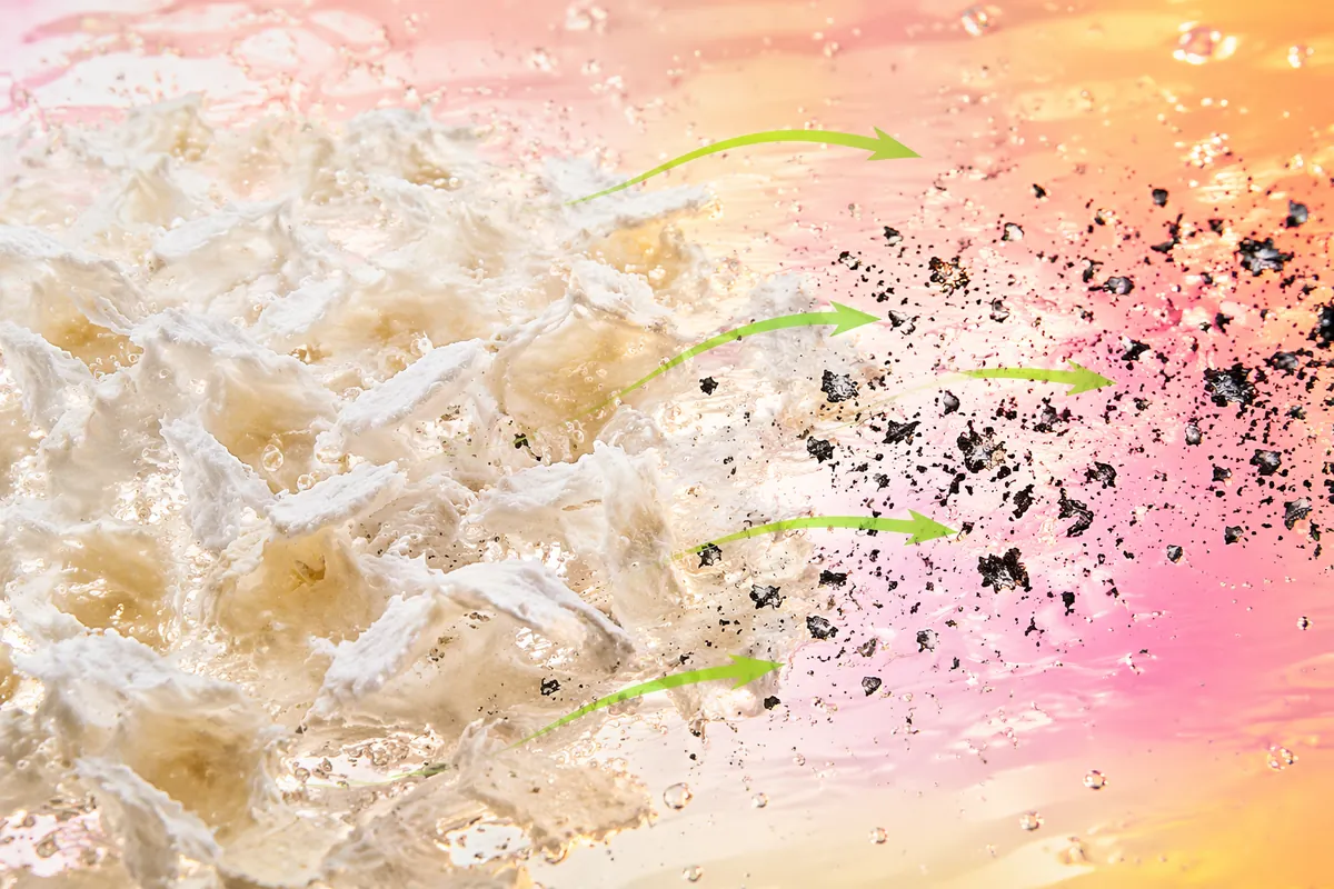 Dark ink particles lifting away from wet recycled pulp fibres during enzyme pretreatment before deinking